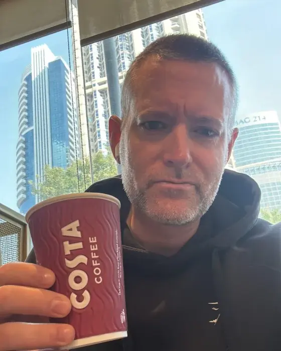Adam, Founder of Positively Adam, enjoying a Costa coffee in Dubai